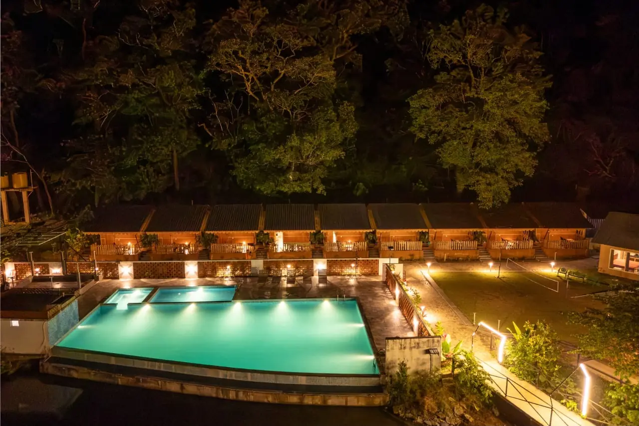 Pool area and cottage row at night